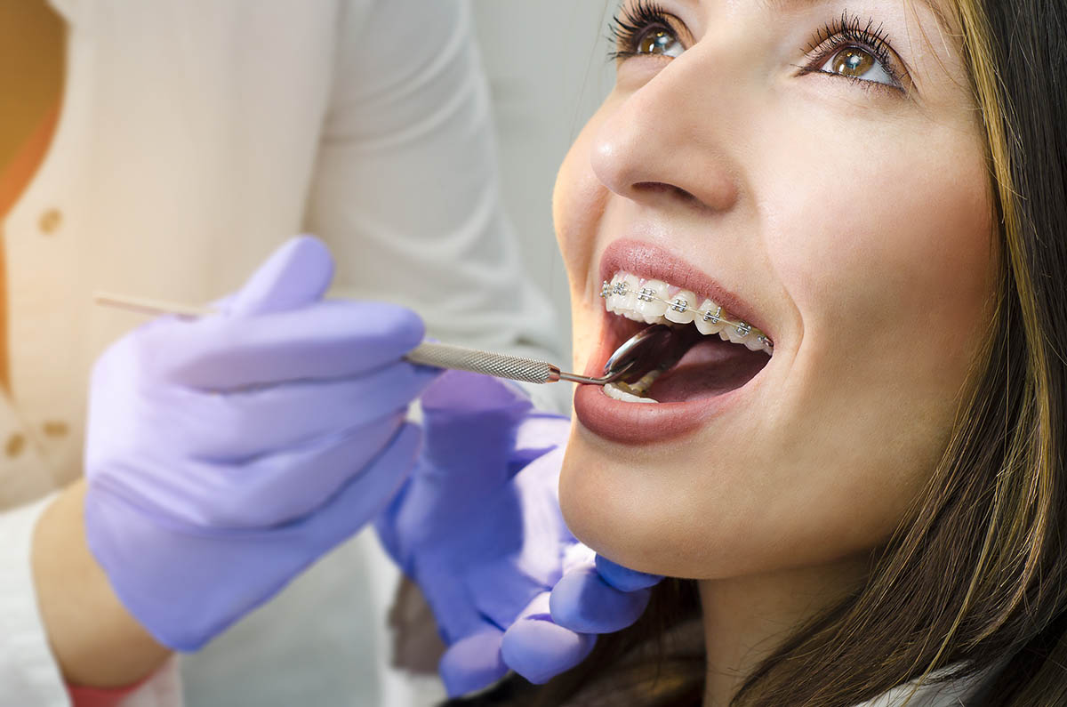 a woman getting a check up after learning about the benefits of orthodontics